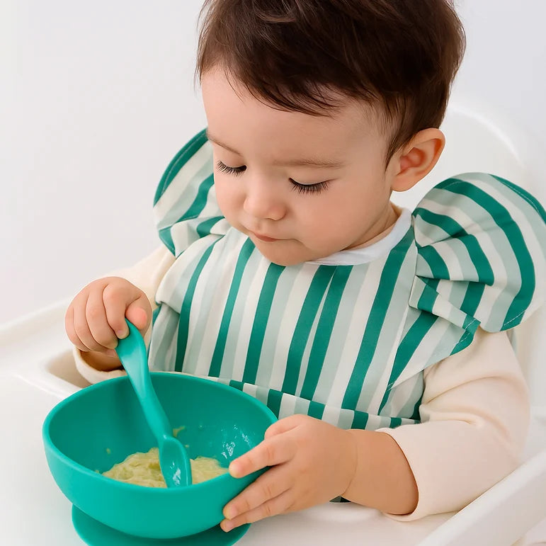 Green meadow baby bib with soft fabric and simple rounded design.